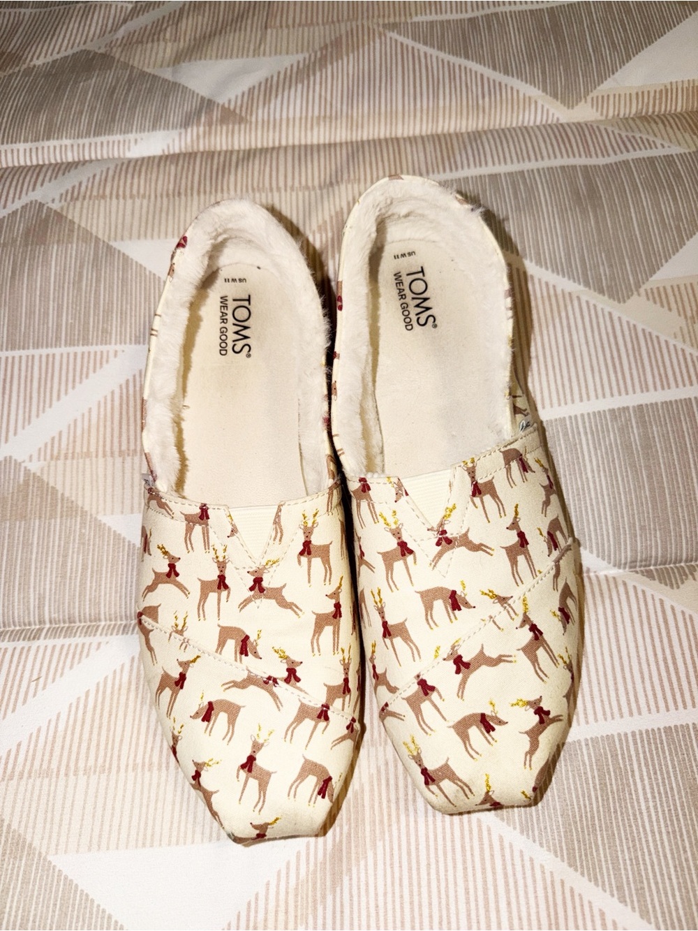 TOMS Cream Canvas Slip-Ons with Brown Reindeer and Gold Antler Accents